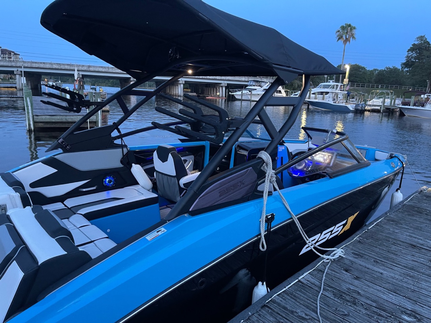 Blue charter boat docked in the evening