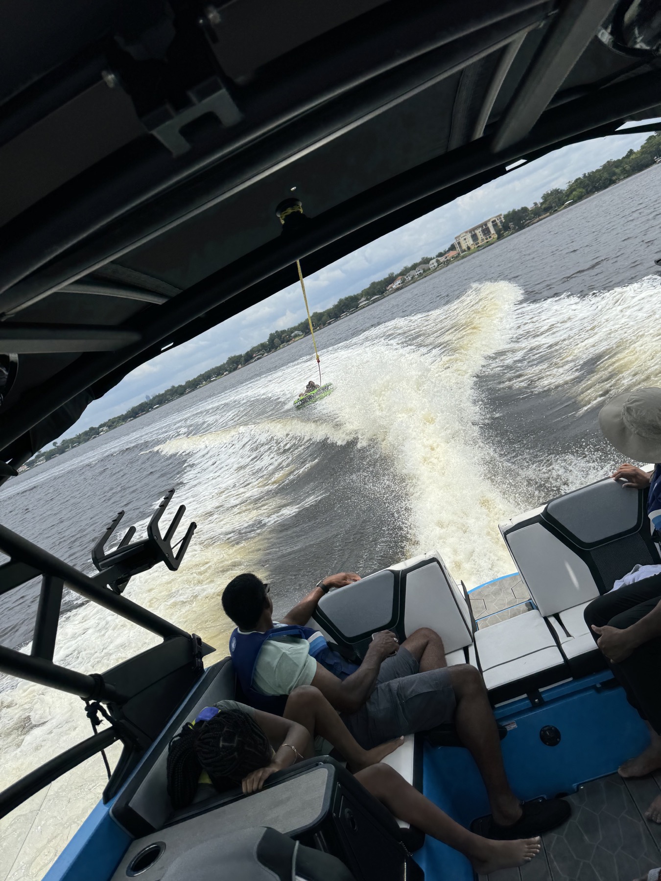 Guests watching tubing from the boat